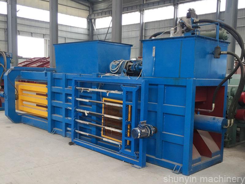 Hydraulic waste baler for compacting a wide range of recyclable materials.  