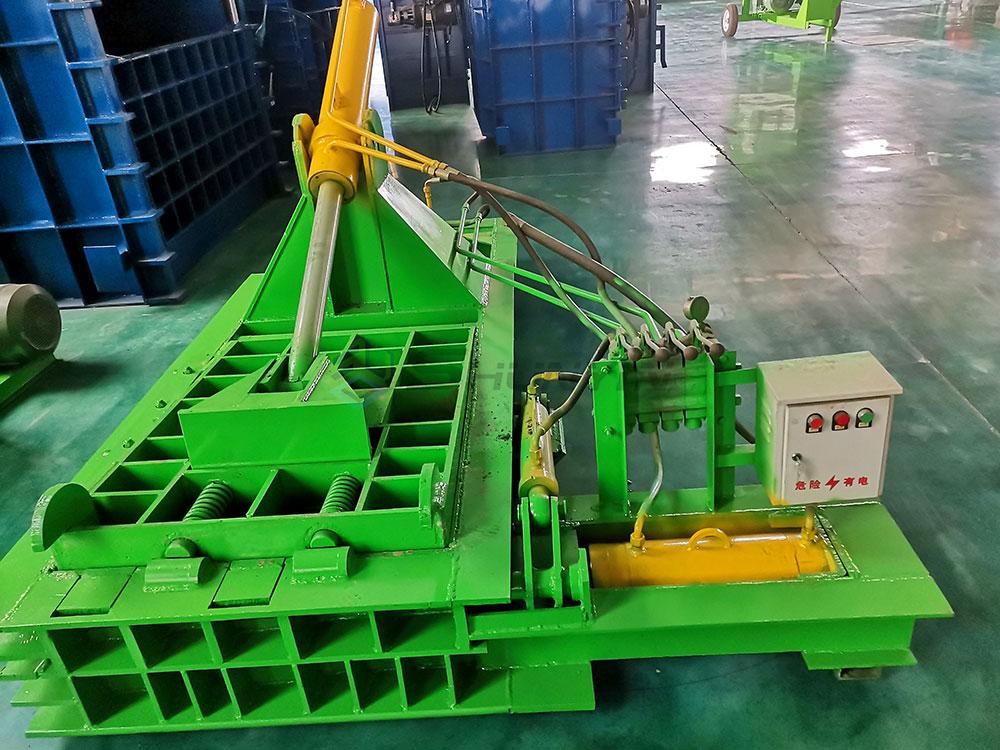 Industrial scrap baling machine operation